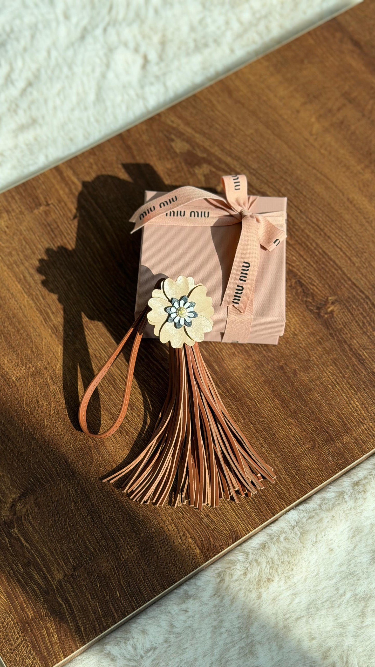 Miu Miu flower-embellished leather keychain trick