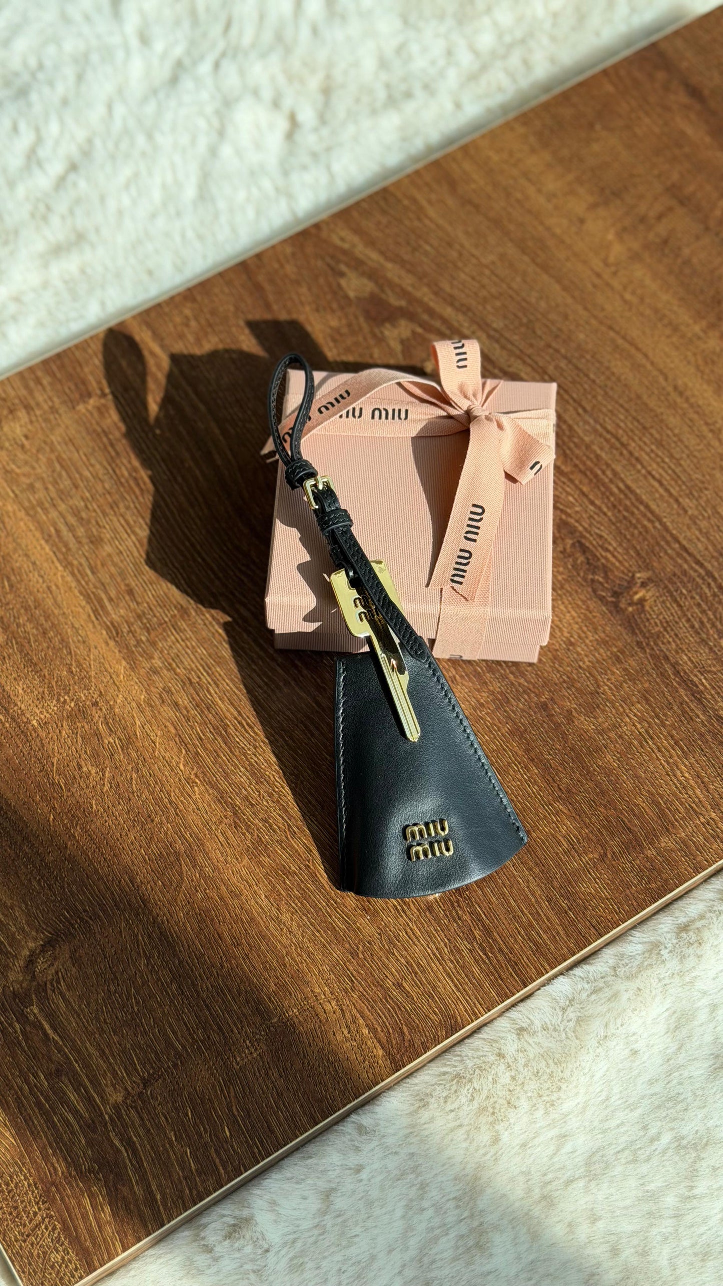 Miu Miu logo-lettering leather trick
