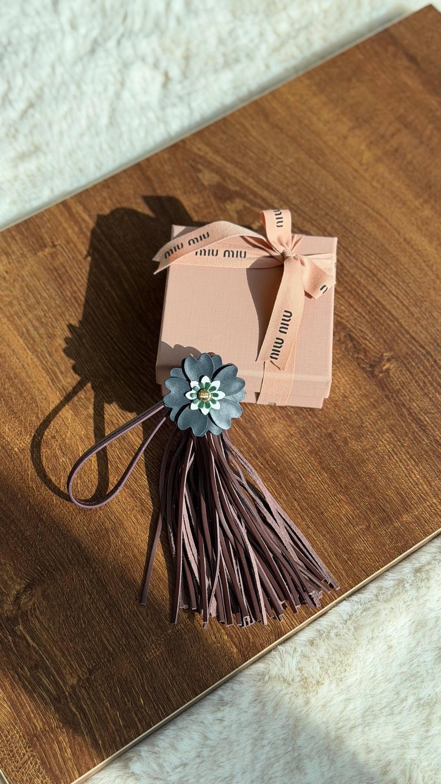 Miu Miu flower-embellished leather keychain trick